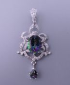 A silver and cubic zirconia pendant. 6 cm high.