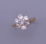 An 18 ct gold and diamond cluster ring. Approximately 1.2 carats. Ring size N.