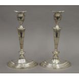 A pair of George III style silver candlesticks with oval bases, with removable sconces. 29 cm high.