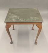 An Arts and Crafts beaten pewter topped table. 51 cm wide.