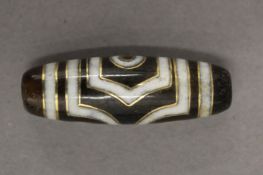 A gold inlaid agate zhi bead. 3.5 cm long.