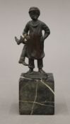A small bronze model of a cobbler boy. 12 cm high.