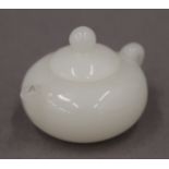 A small model teapot. 3 cm high.