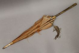 A Meiji Period parasol with gilt metal decorated handle. 86.5 cm long.