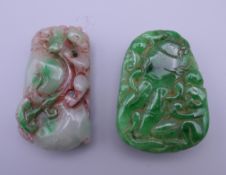 Two carved jade pendants. The largest 5.5 cm high.