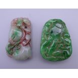 Two carved jade pendants. The largest 5.5 cm high.