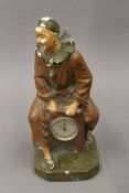 A vintage plaster clock formed as Pierrot. 30 cm high.