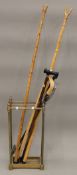 A Victorian brass stick stand and a collection of sticks. The former 62.5 cm high.