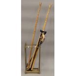 A Victorian brass stick stand and a collection of sticks. The former 62.5 cm high.