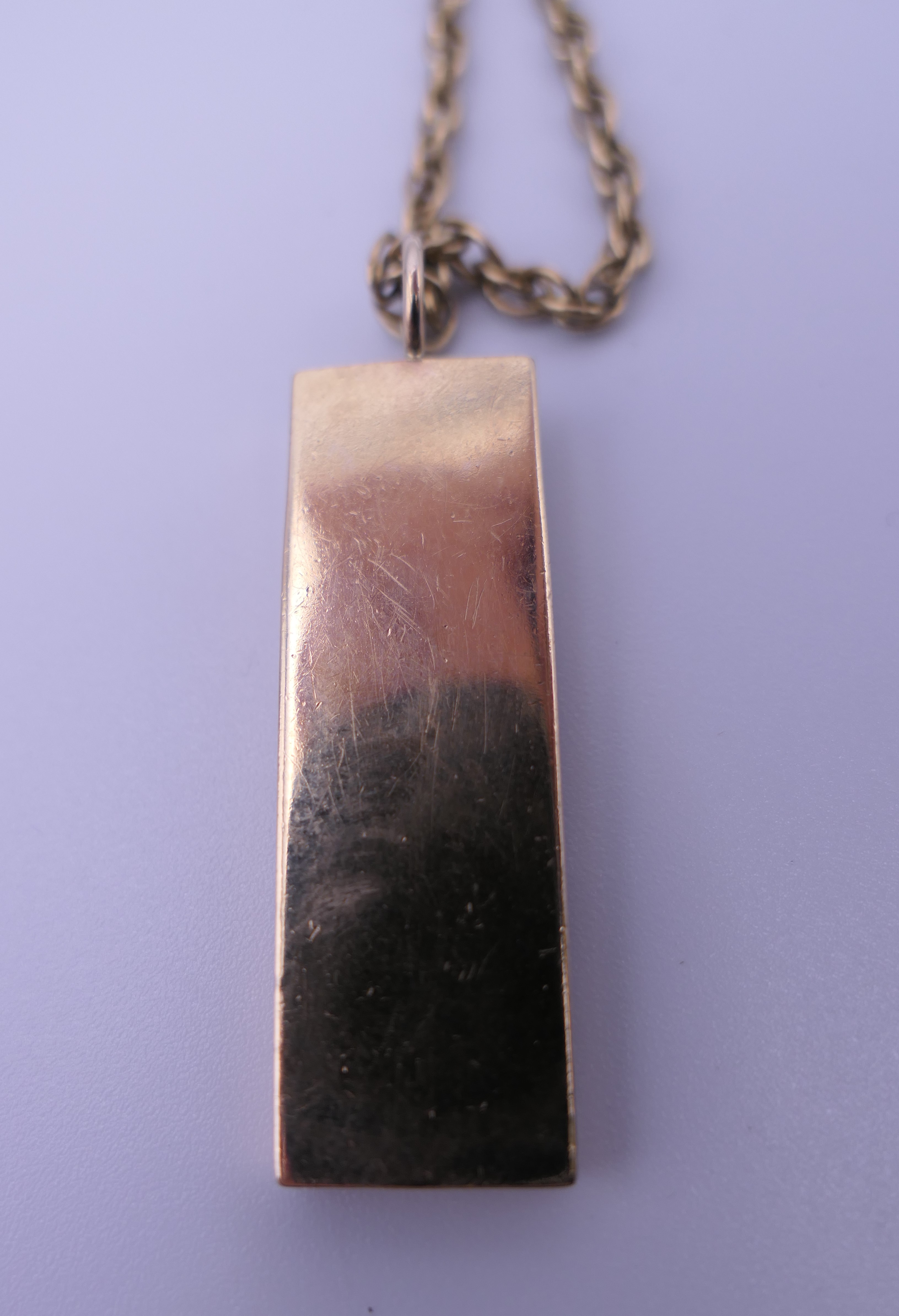 A 9 ct gold ingot on a 9 ct gold chain. 27.1 grammes. - Image 2 of 5