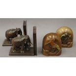 Two pairs of carved wooden bookends, one formed with elephants, the other carved with birds.