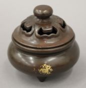 A Chinese bronze gold splash lidded censer. 9 cm high.