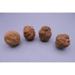 Four Eastern carved figures. Each approximately 3 cm high.