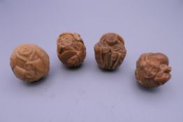 Four Eastern carved figures. Each approximately 3 cm high.