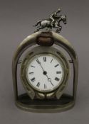 An early 20th century horseshoe and stirrup form clock. 25 cm high.