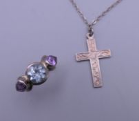 A silver cross and chain, and a silver ring. The cross 3 cm high.