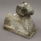 A stone carving of a ram. 24 cm high.