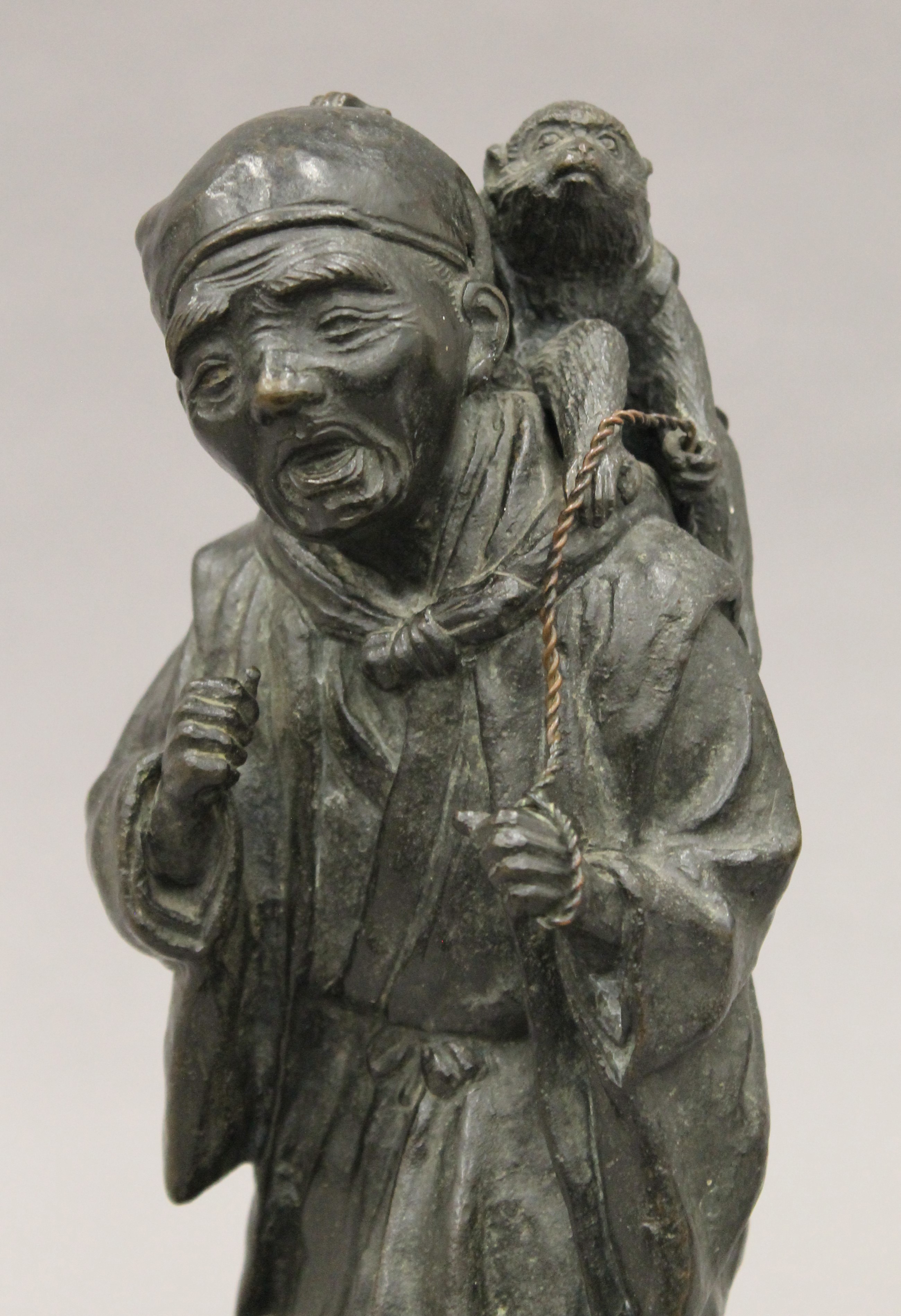 A Japanese Meiji period bronze model of a man with a monkey. 32 cm high. - Image 3 of 7