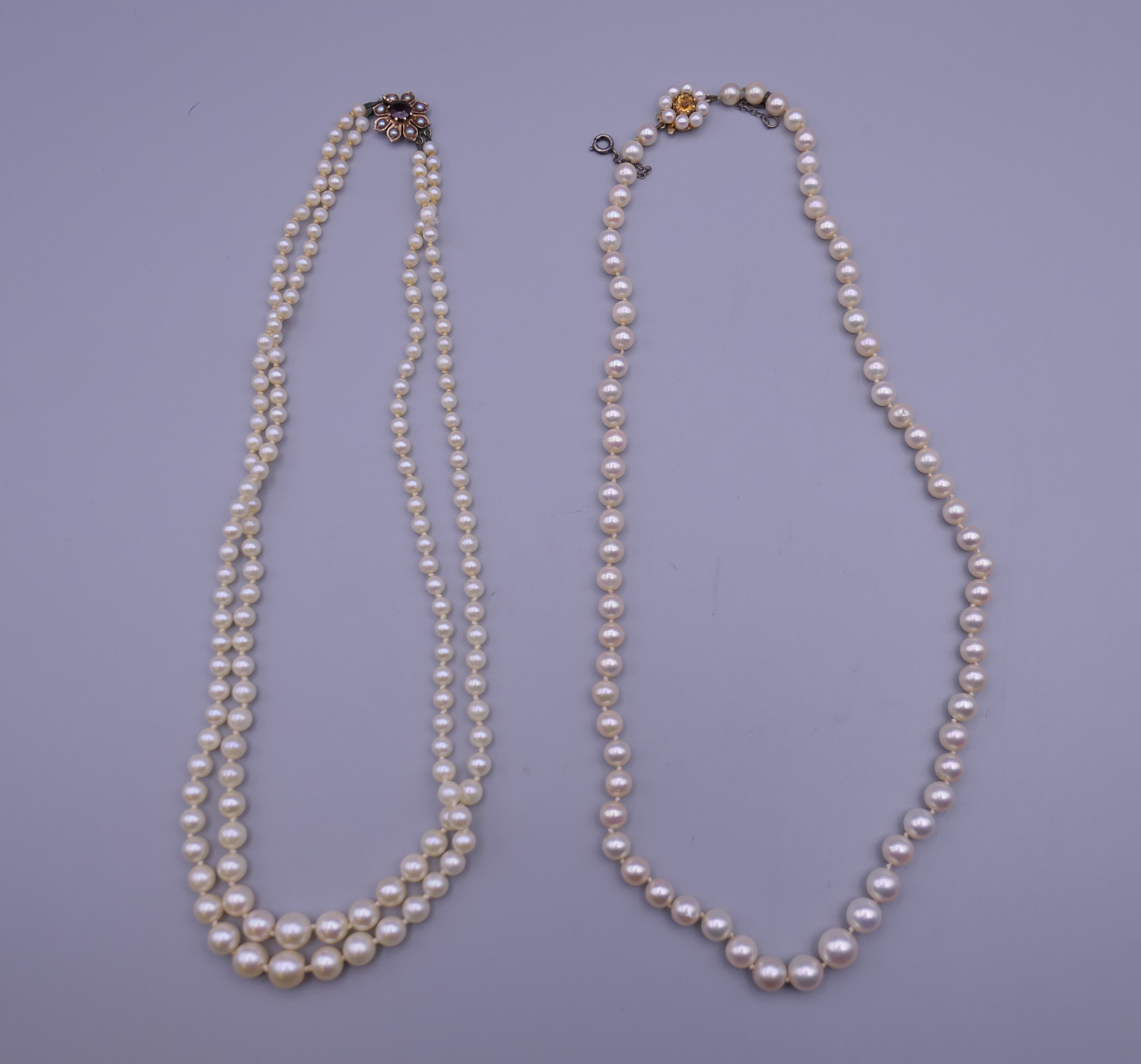 Two pearl necklaces, each with a 9 ct gold clasp.