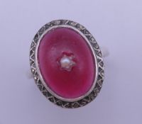 A cherry amber set unmarked white metal ring. Ring size P/Q.