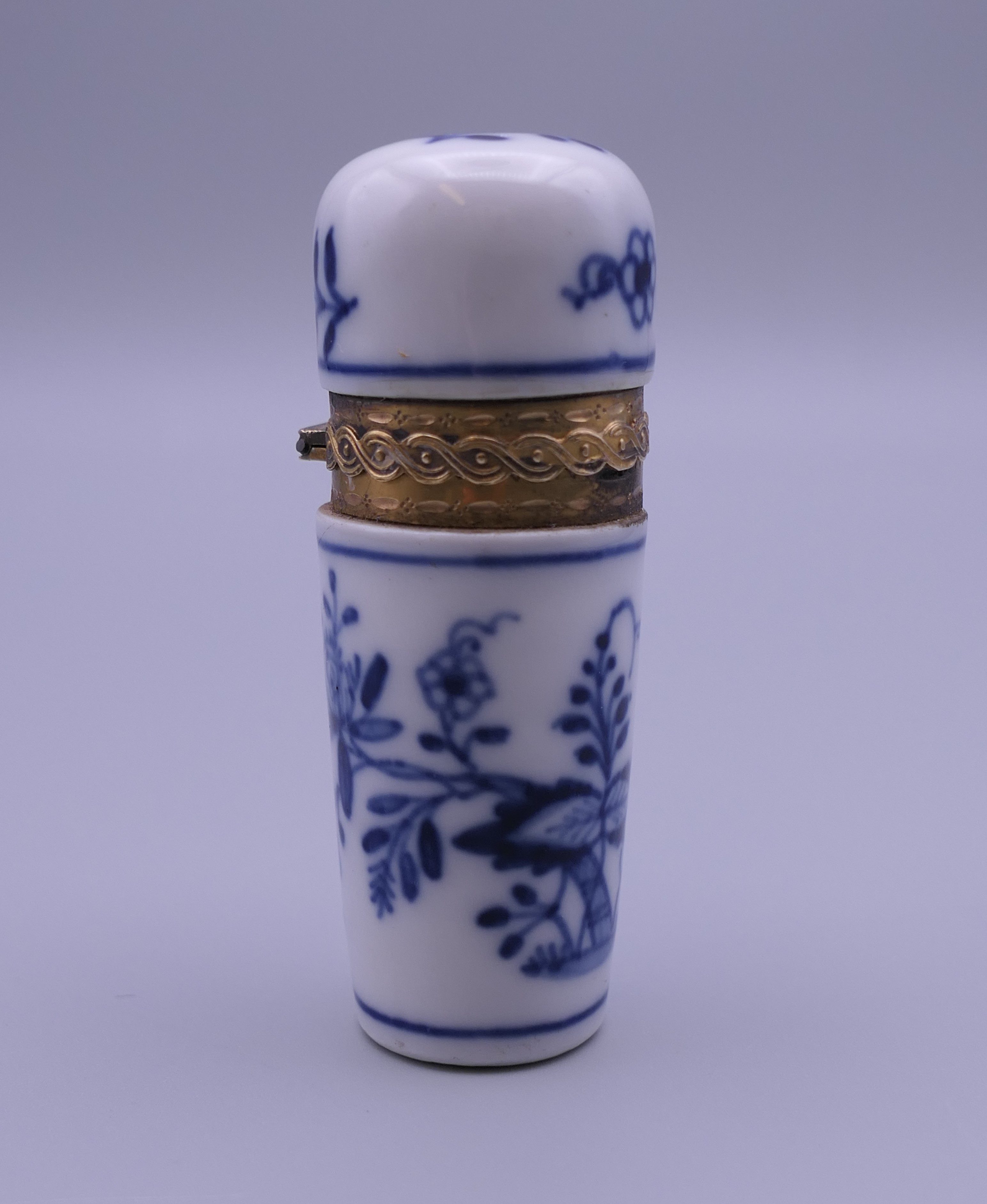 An unmarked gold mounted blue porcelain scent bottle. 6.5 cm high.