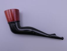 A wood bowled novelty pipe in the form of a lady's shapely leg. 13.5 cm long.