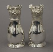 A pair of silver plated dog formed peppers. 10.5 cm high.