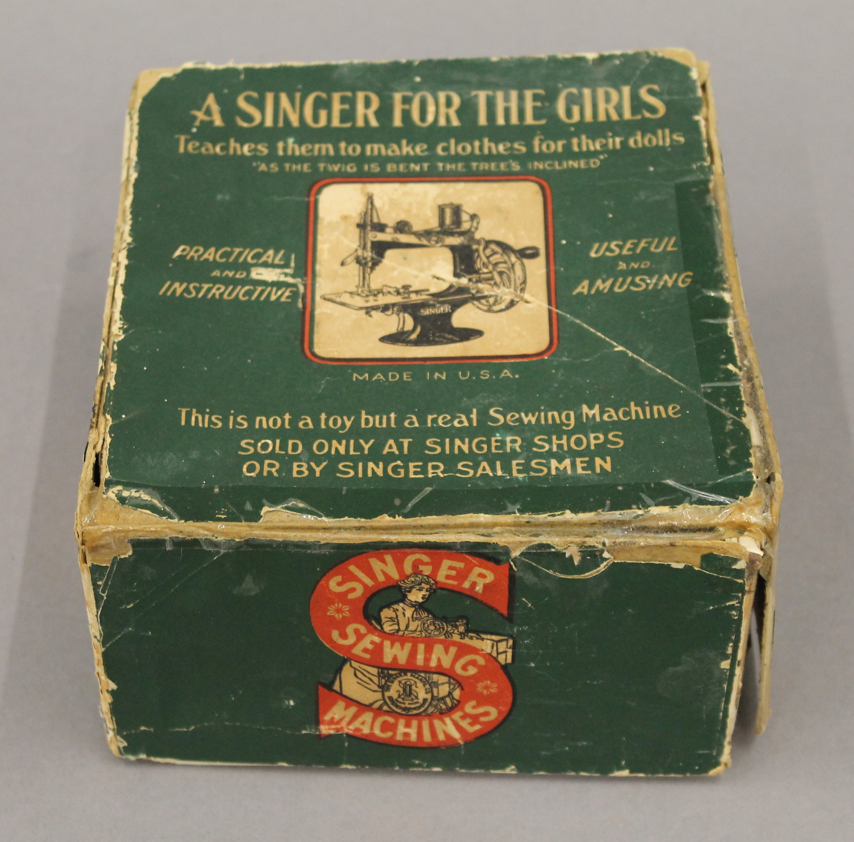 A boxed Singer For the Girls sewing machine. The box 18 cm wide.