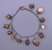 A unmarked gold bracelet with twelve silver gilt and enamelled charms. Approximately 18 cm long.