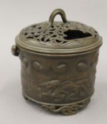 A Chinese bronze pierced topped censer, with handles. 14 cm wide.