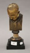 A patinated plaster bust mounted on a black slate base. 28 cm high.