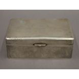 A Chinese silver cigarette box. 15.5 cm wide. 19.1 troy ounces total weight.