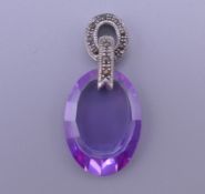 A silver and amethyst pendant. 3 cm high.