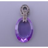 A silver and amethyst pendant. 3 cm high.