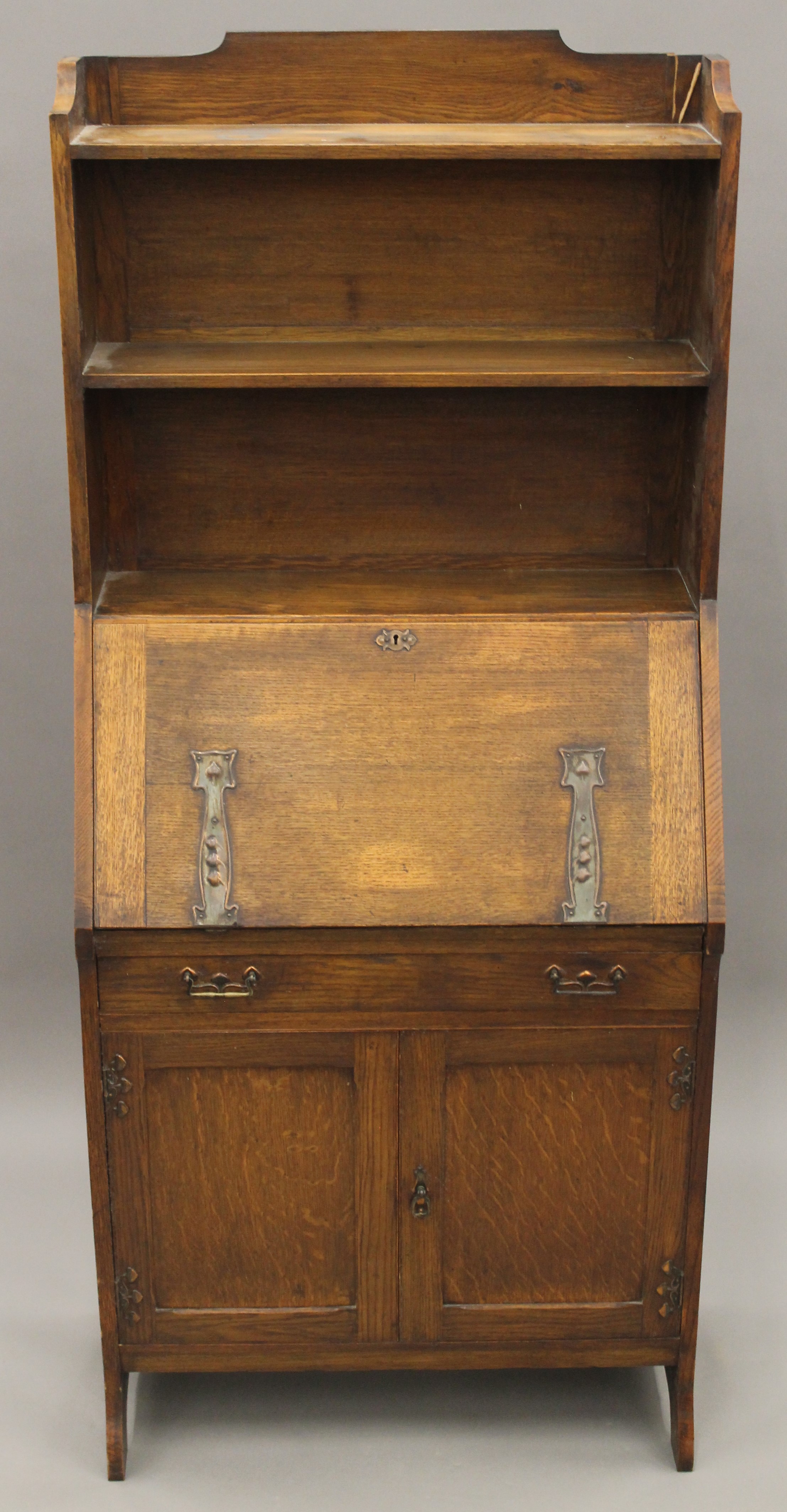 An Arts and Crafts oak hall bureau bookcase. 76 cm wide.