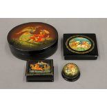 Four Palekh Russian lacquered papier mache boxes. The largest 14 cm wide.