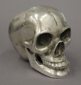 A silver plated model of a skull. 8.5 cm high.