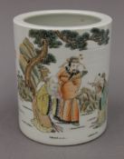 A Chinese porcelain brush pot decorated with figures. 15 cm high.