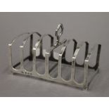 A silver toast rack. 11 cm long. 2.6 troy ounces.