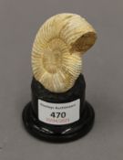 A small ammonite on a display stand. 9 cm high overall.