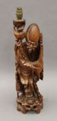 An early 20th century carved wooden table lamp formed as Shoa Loa. 59 cm high.