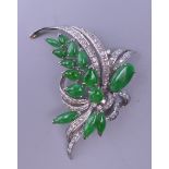 An 18 K white gold diamond and jade floral spray brooch. 5.5 cm wide. 15.1 grammes total weight.