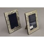 A pair of silver photograph frames. 18.5 cm high.