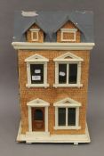 A vintage dolls house. 62 cm high.