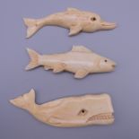 A carved bone fish, a carved bone sperm whale and a carved bone dolphin. The latter 8 cm long.