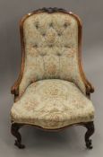 A Victorian walnut framed button back arm chair. 56 cm wide.