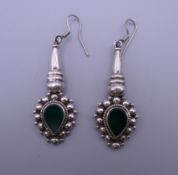 A pair of silver and jade earrings. 4.5 cm high.