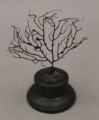 A black coral specimen on a display stand. 16 cm high overall.