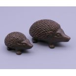 Two bronze hedgehogs. The largest 5 cm long.