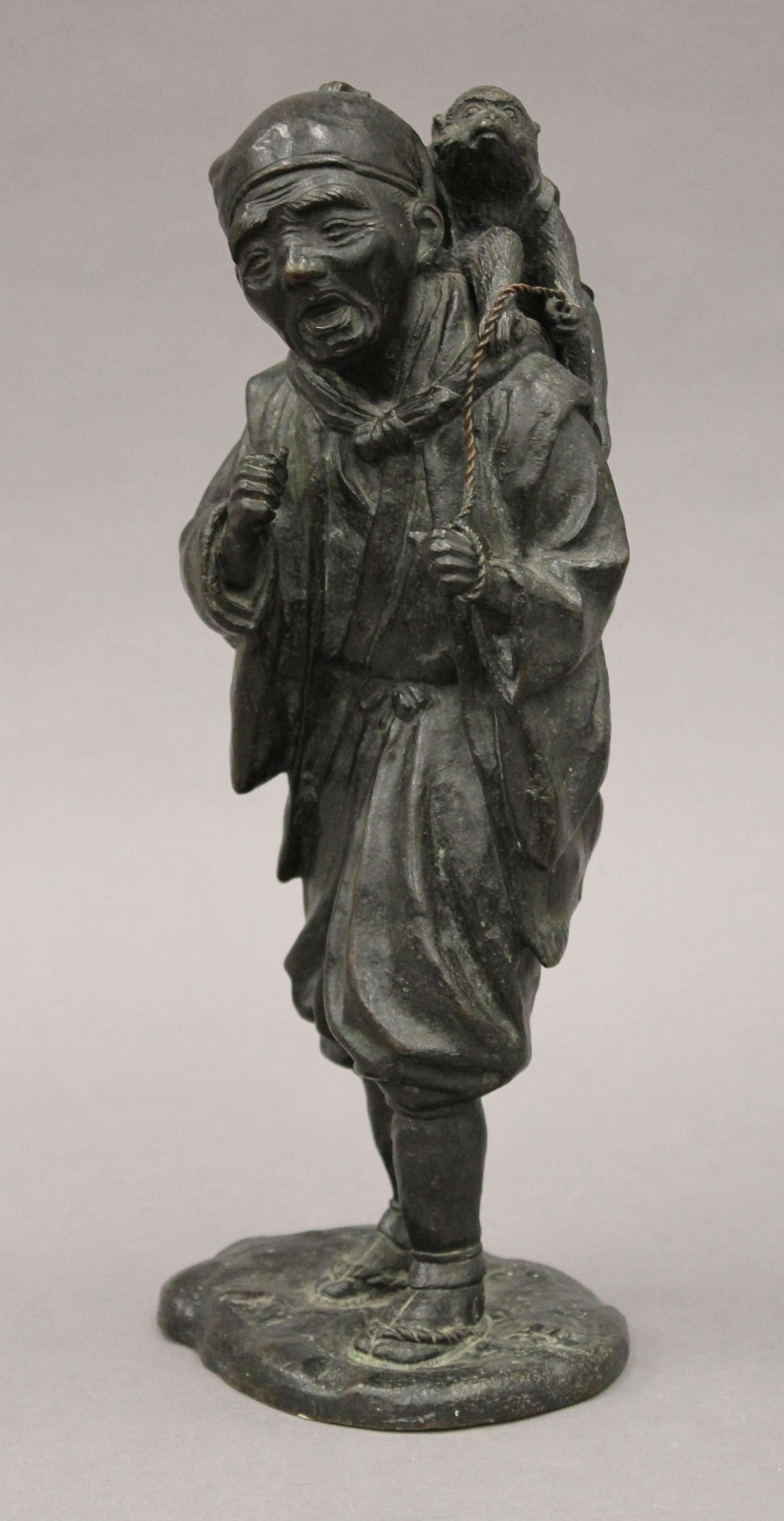 A Japanese Meiji period bronze model of a man with a monkey. 32 cm high. - Image 2 of 7